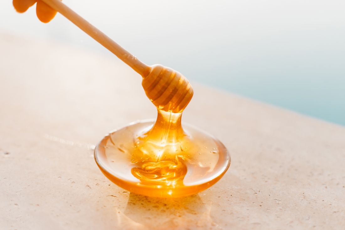 Honey dripping off a dipper